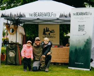 Jake Green, Founder of The Bear&Wolf Co, pictured in front of their first stall at The Gordon Castle Highland Games. Also pictured are his children stood beside him.