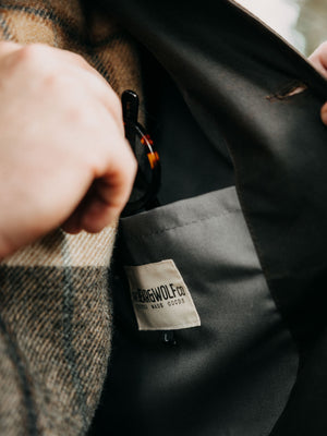 Interior pocket and Bear&Wolf woven label inside the Cairn waxed cotton overshirt in Raven