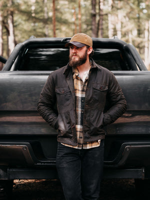 Cairn British-made waxed cotton overshirt in Raven worn outdoors in a Scottish woodland