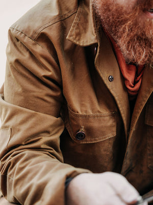 Close-up of the Cairn British-made waxed cotton overshirt in Whisky showing the fabric, stitching and chest pocket
