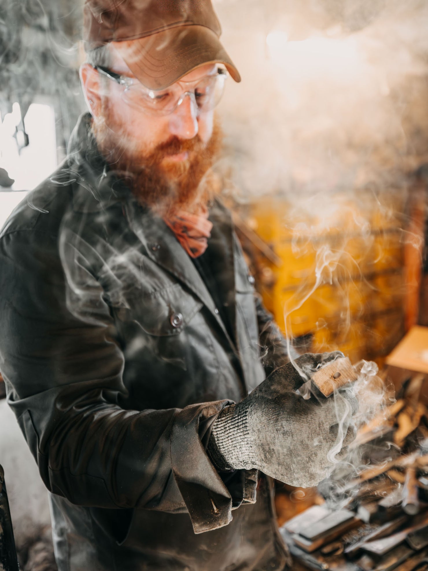 Matty from Flettforge crafting a handmade knife in his Scottish workshop whilst wearing a Bear and Wolf Cairn Overshirt in Raven.