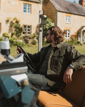 Bear&Wolf founder Jake Green modelling the stac in kelp green on a photoshoot in the cotswolds in a classic series landrover.