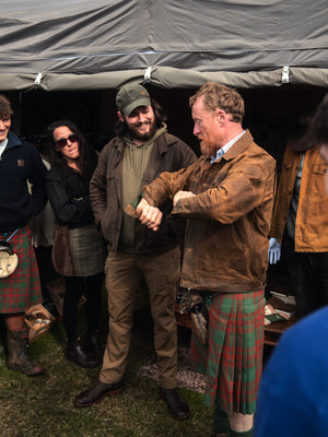 A member of the public at a Highland Games Event trying on the Stac in Saddle Brown at the Bear&Wolf stall.