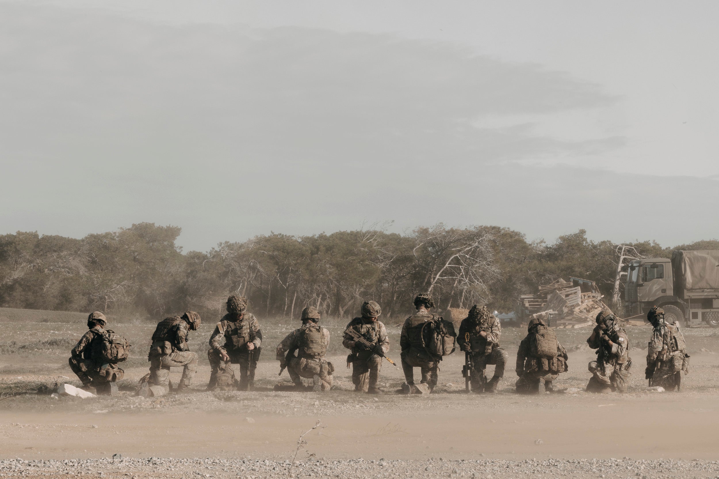 RAF Regiment personnel moving across dusty terrain during a field exercise in Cyprus